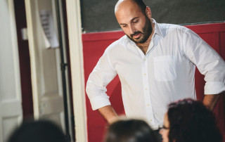 Reflective therapist providing support and guidance to a diverse group, fostering emotional well-being and personal growth in a warm, professional environment.