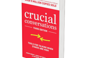 Clear, close-up shot of the book "Crucial Conversations" Third Edition, focusing on effective communication tools and strategies for high-stakes conversations in personal and professional settings.