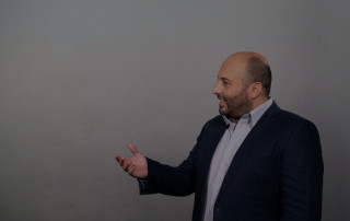 Insightful man engaging in a conversation or presentation, emphasizing communication and emotional expression, highlighting skills in interpersonal connection and professional interaction.